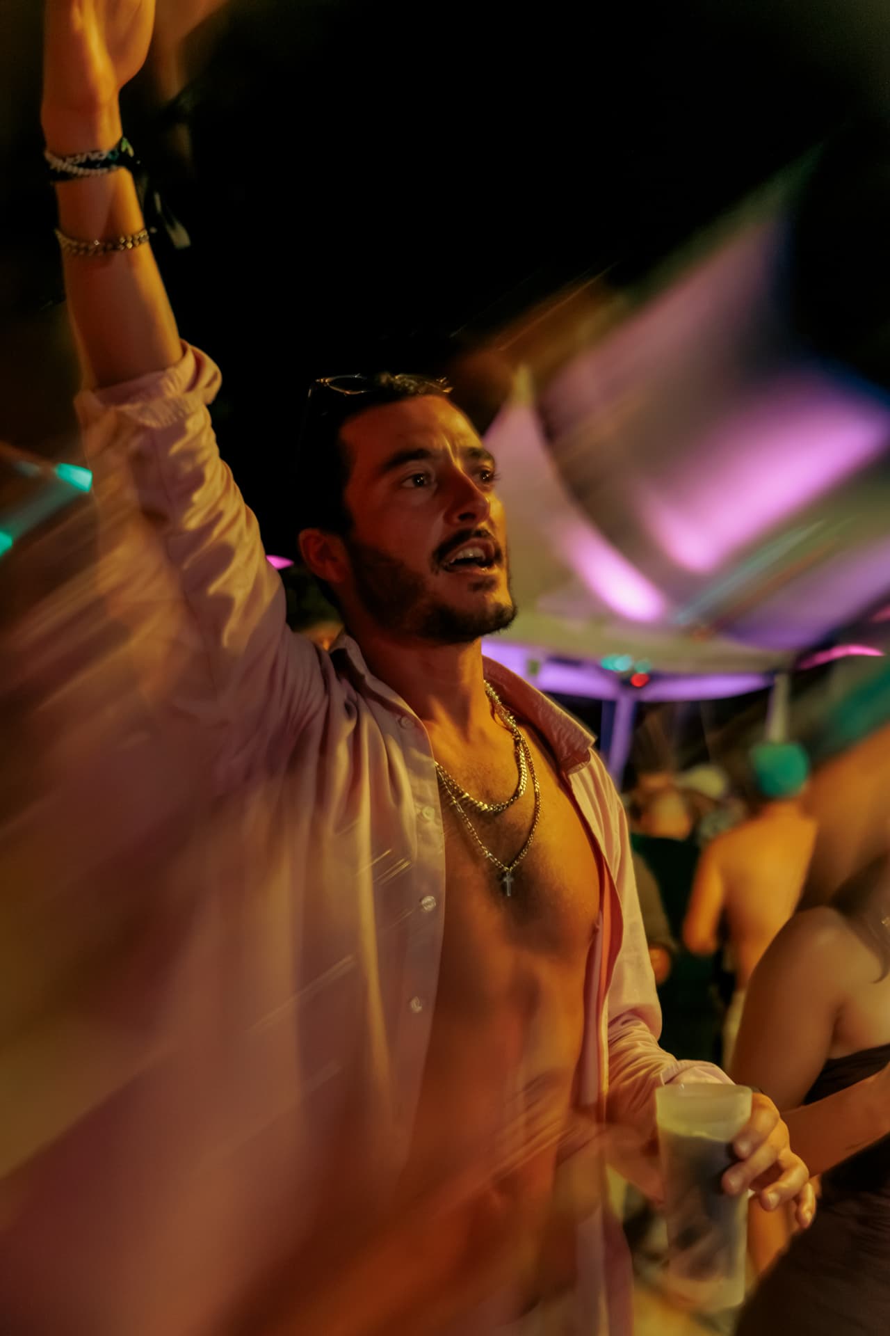 Guest dancing under pink and magenta light