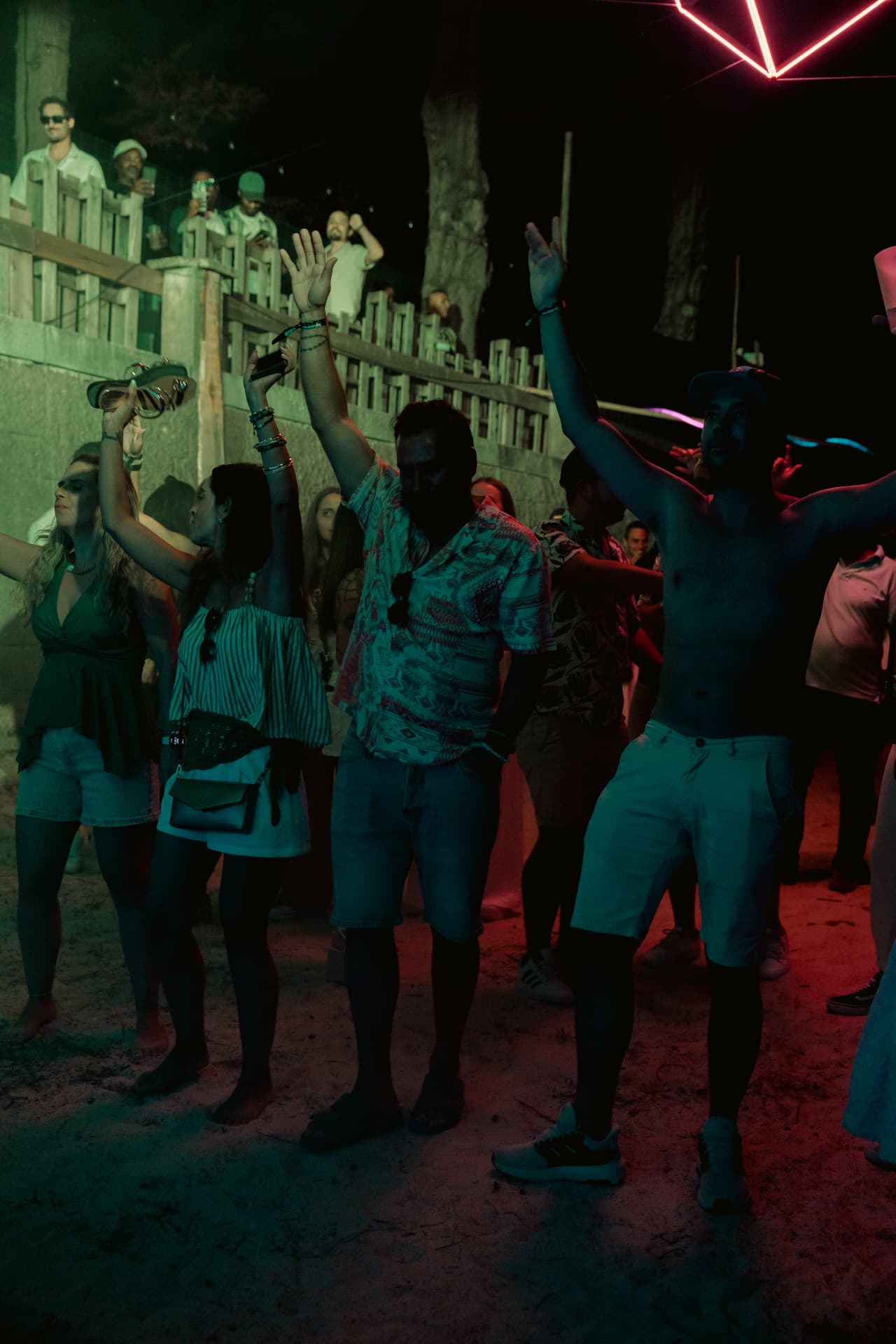 Crowd dancing with arms in the air
