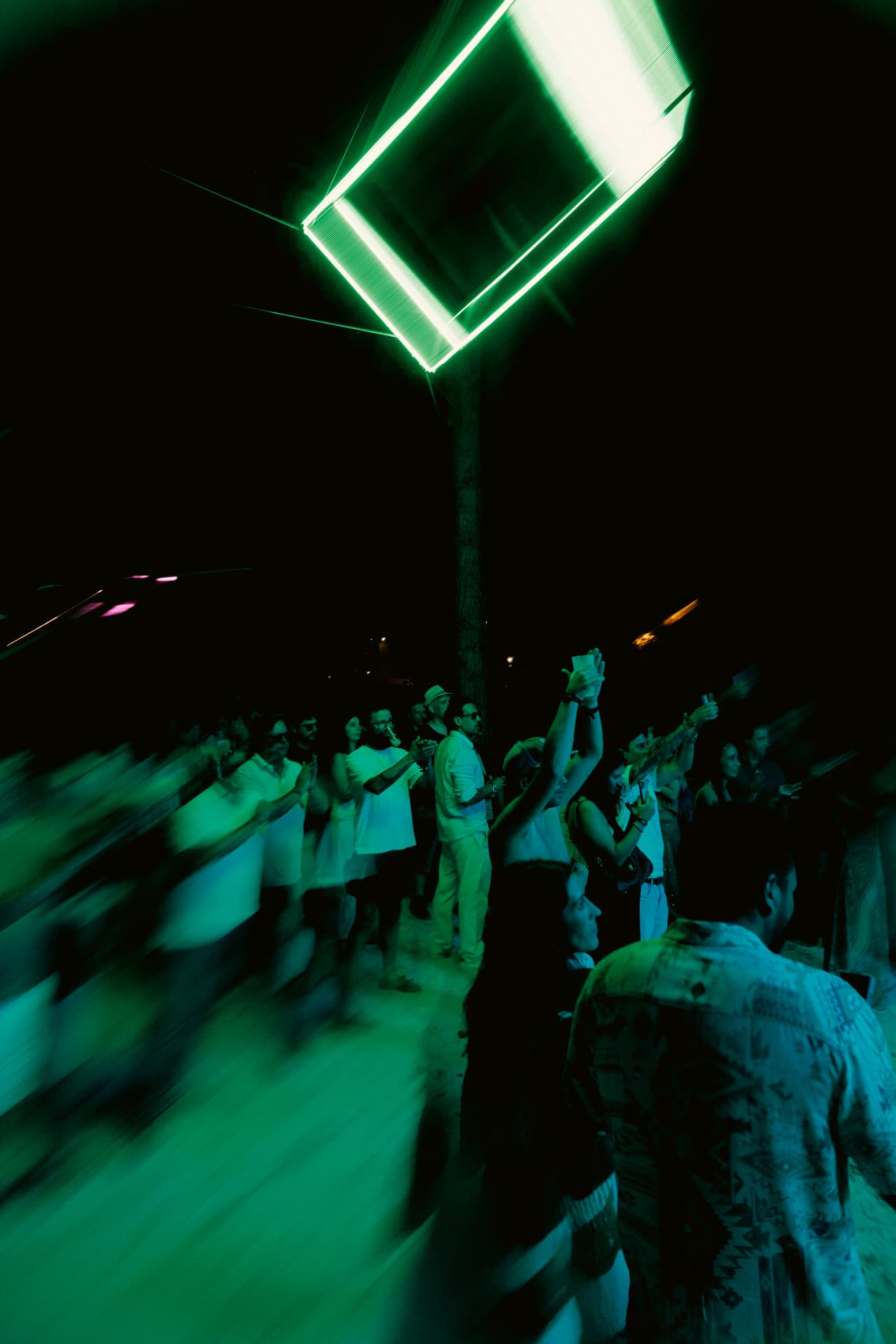 Green cube glowing above the dancers