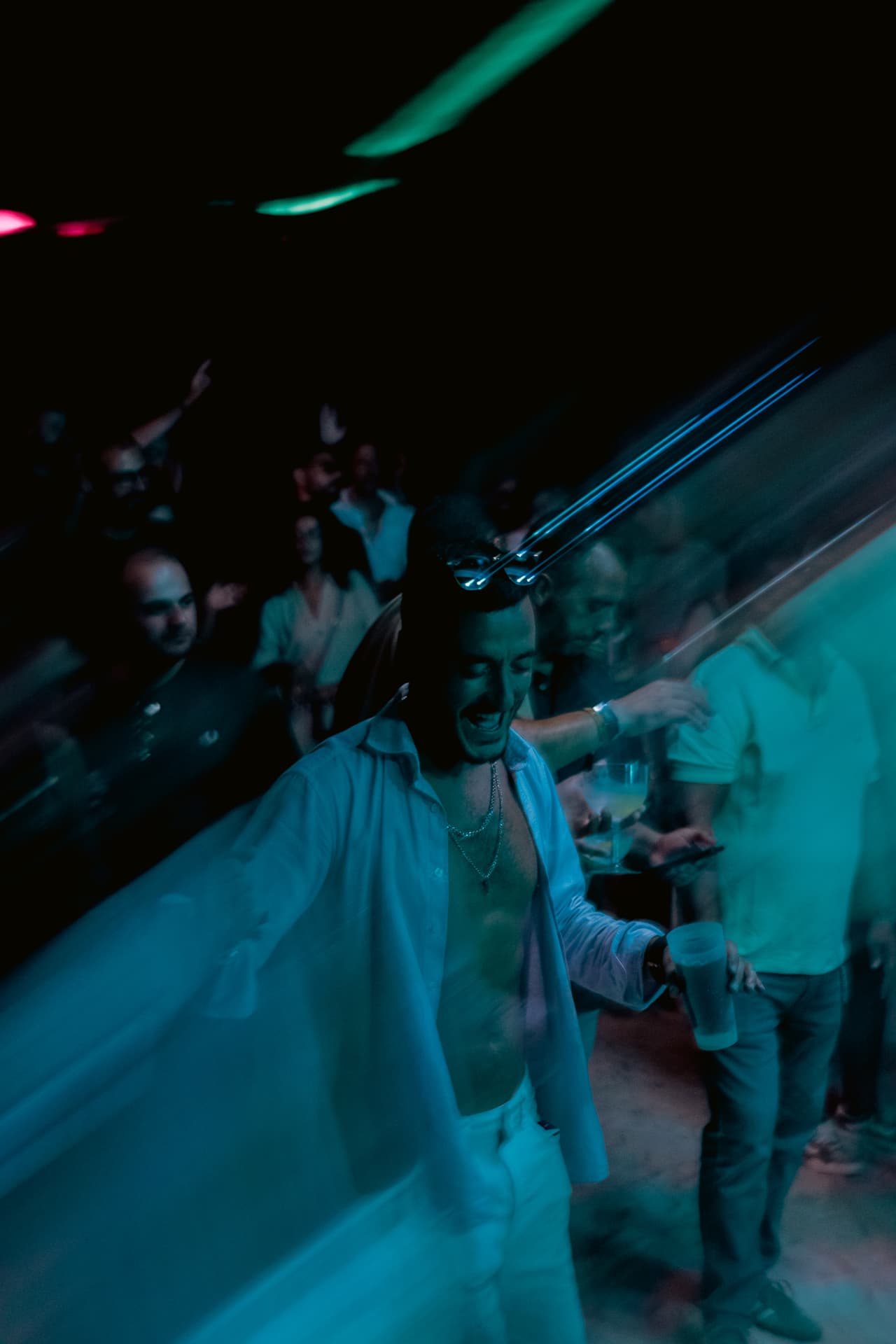 Dancer in teal light, motion blur