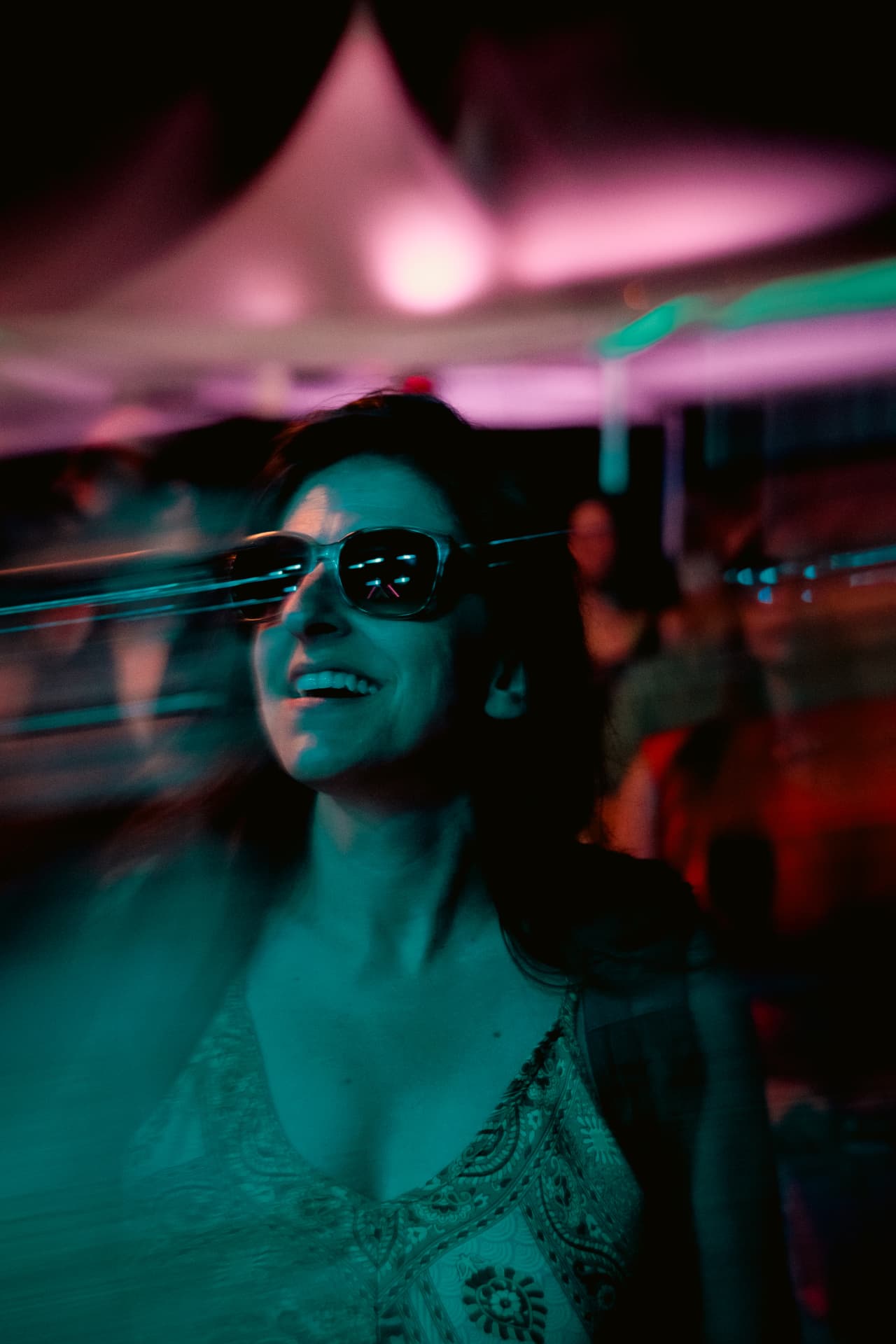 Guest laughing beneath the magenta canopy